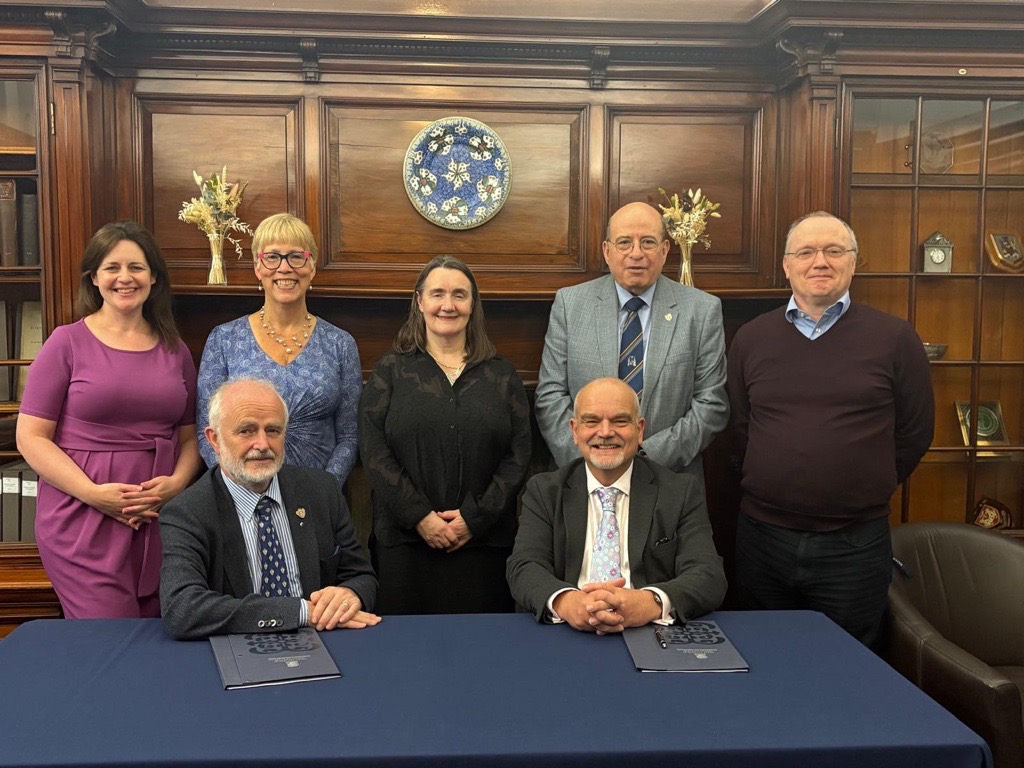 The signing was attended by (back row) Kat Hannah, College Director of Communications and Marketing; Dr Rebecca Wheater, SHARP Honorary Secretary; Professor Mary Joan Macleod, SHARP Chair; Professor Hany Eteiba, College President; Kenneth Osborne, College Director of Finance, Operations and ICT Services; and (front row) Dr William Simpson, SHARP Honorary Treasurer; and Muir Brown, College Director of Membership, Heritage and Governance.